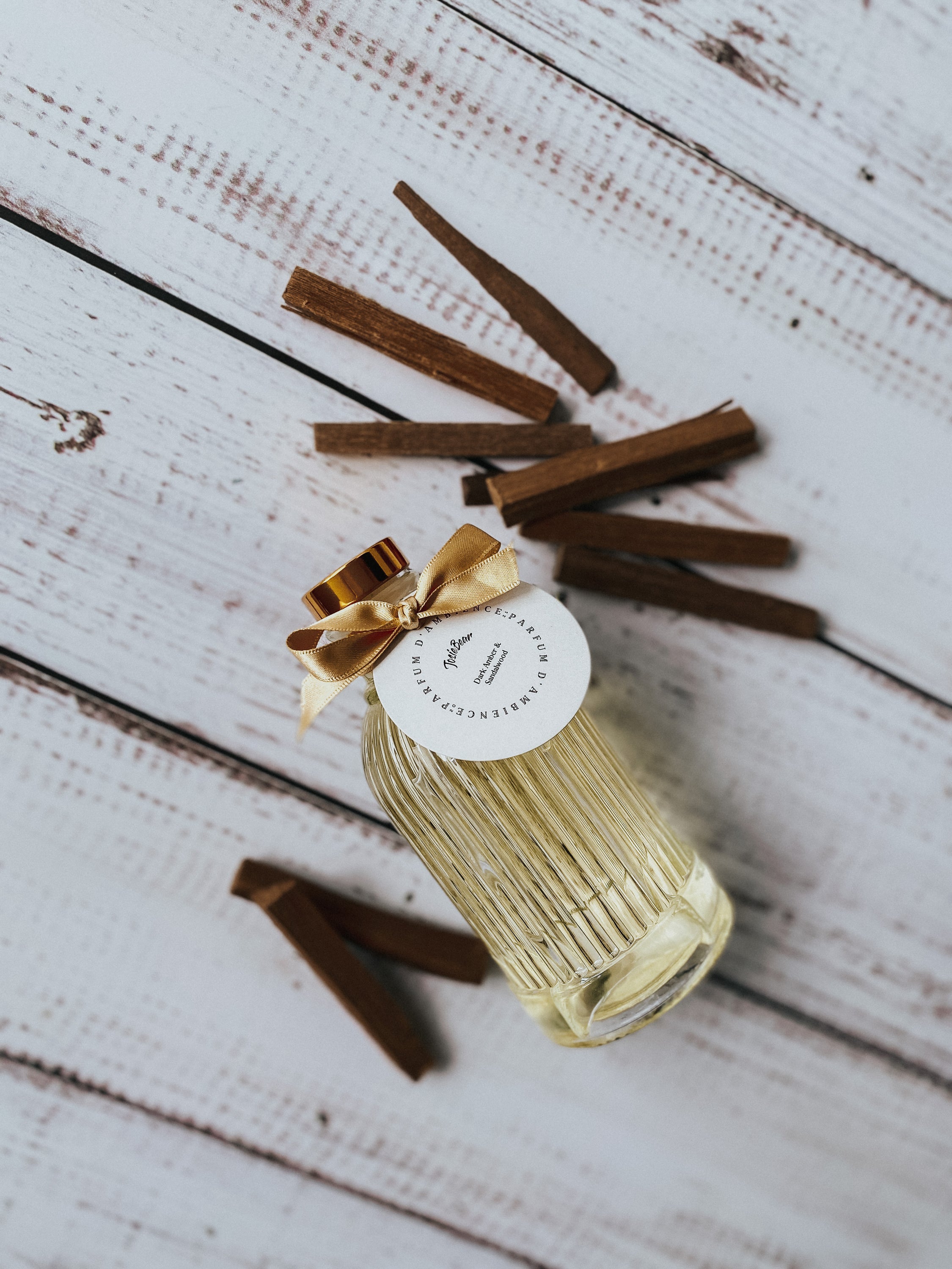 Dark Amber & Sandalwood Reed Diffuser in a stylish glass bottle with rattan reed sticks, showcasing a warm and earthy fragrance.