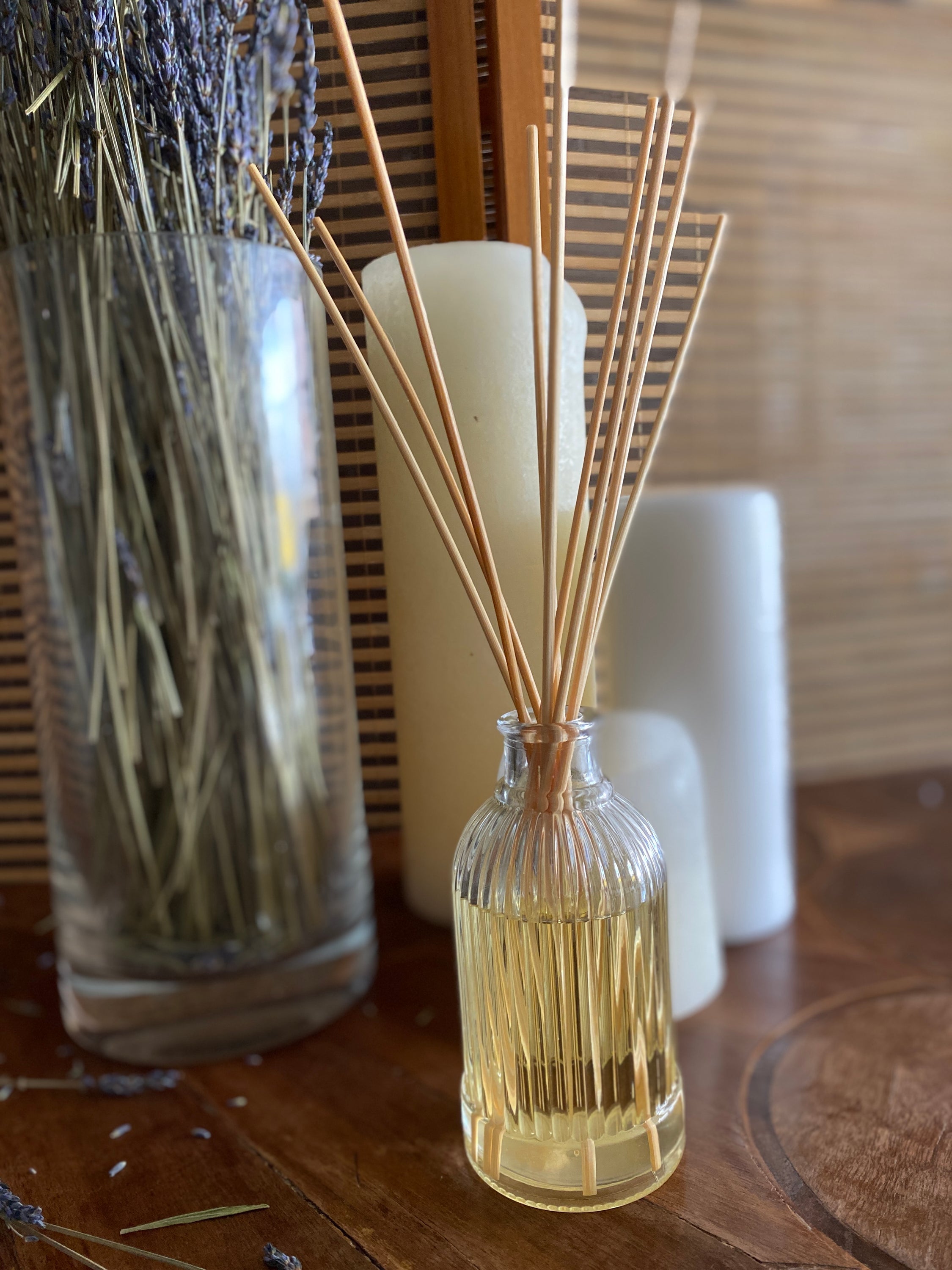 Dark Amber & Sandalwood Reed Diffuser in a stylish glass bottle with rattan reed sticks, showcasing a warm and earthy fragrance.