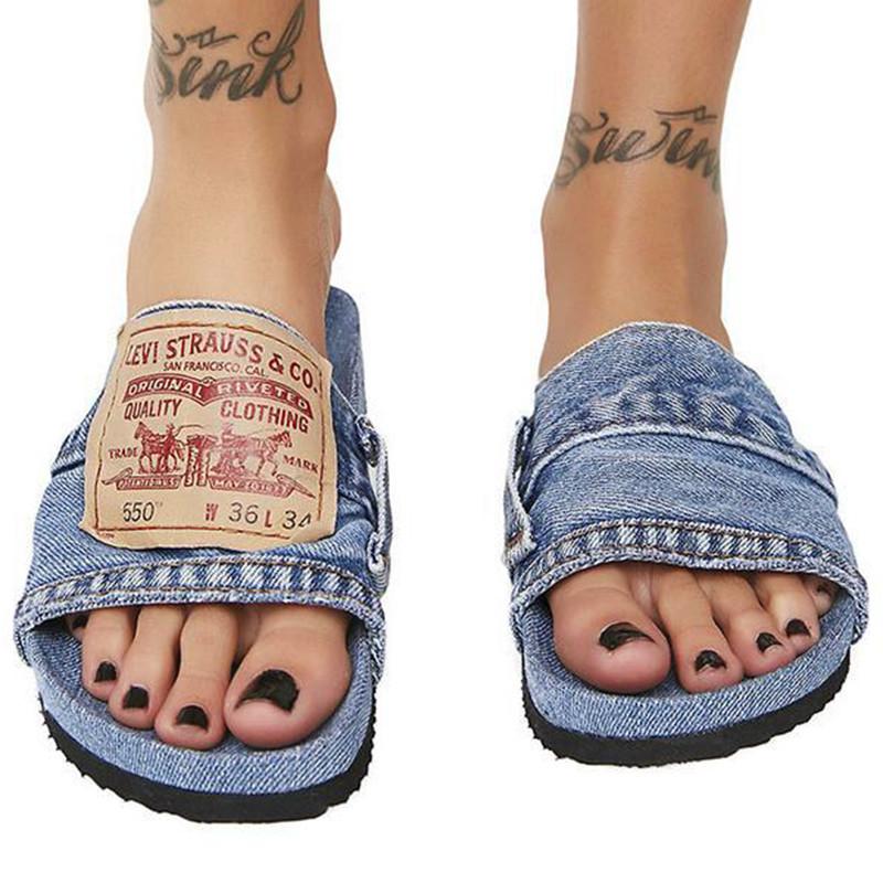 Denim Women's Cool Round Head Flat Slides in blue and black, showcasing a stylish round head design and comfortable flat sole.