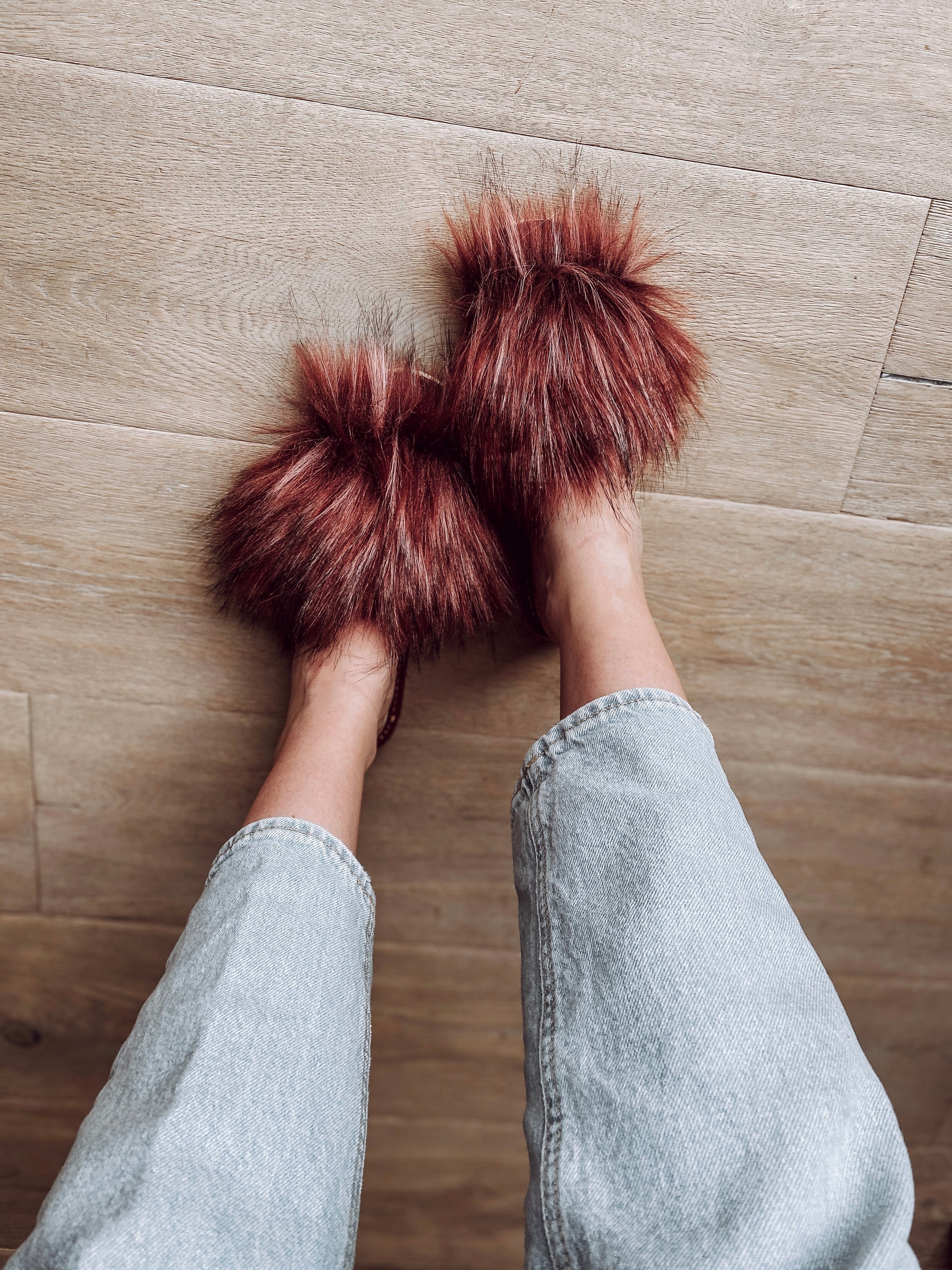 Cozy faux fur pink slippers with cushioned insole and foam bottom, perfect for home wear.