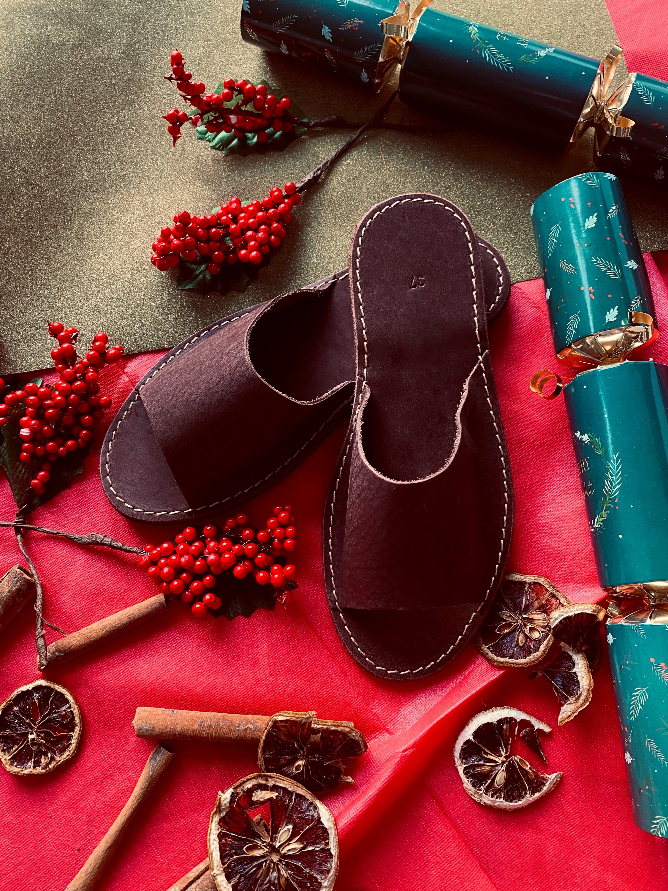 Chocolate leather open toe slippers with a minimalistic design, showcasing their handmade craftsmanship and thick sole for comfort.