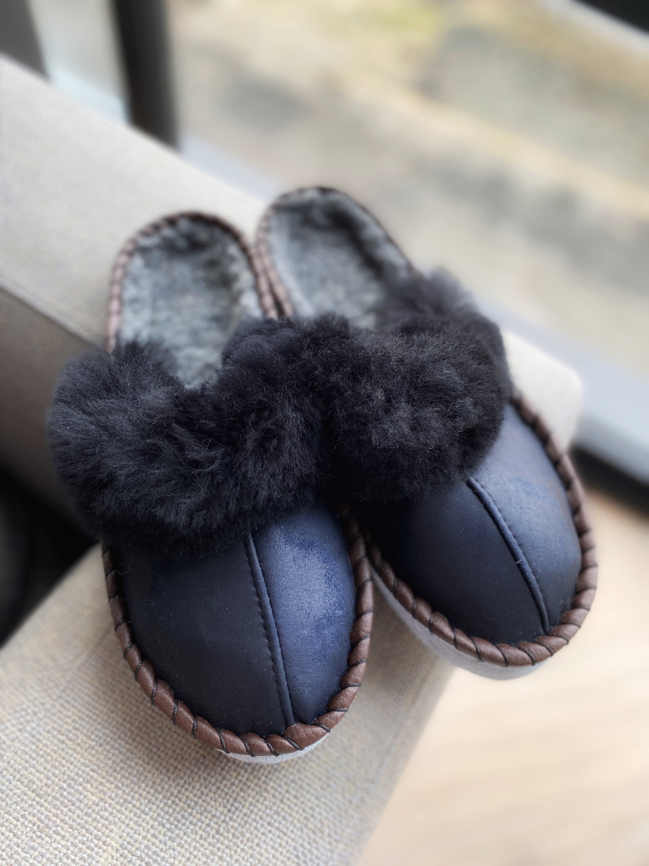 Mens Onyx Black Slip Ons featuring black leather and fur cuff, showcasing a stylish and comfortable design.