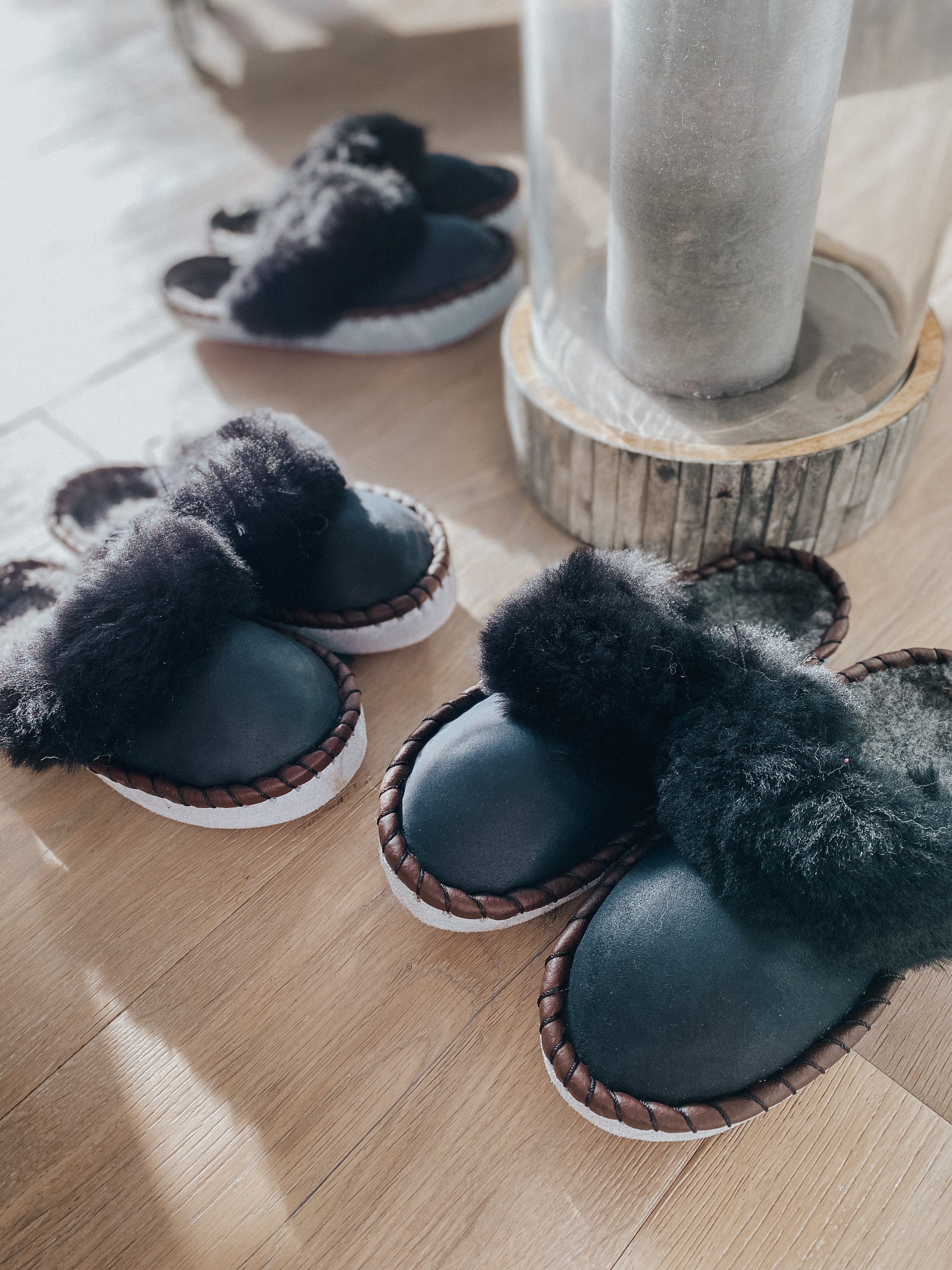 Mens Onyx Black Slip Ons featuring black leather and fur cuff, showcasing a stylish and comfortable design.