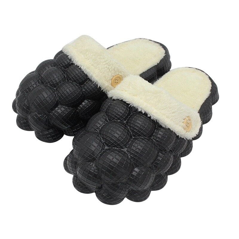 A pair of Non-slip Warm Cotton Bubble Slides in a cozy indoor setting, showcasing their soft cotton material and non-slip sole.