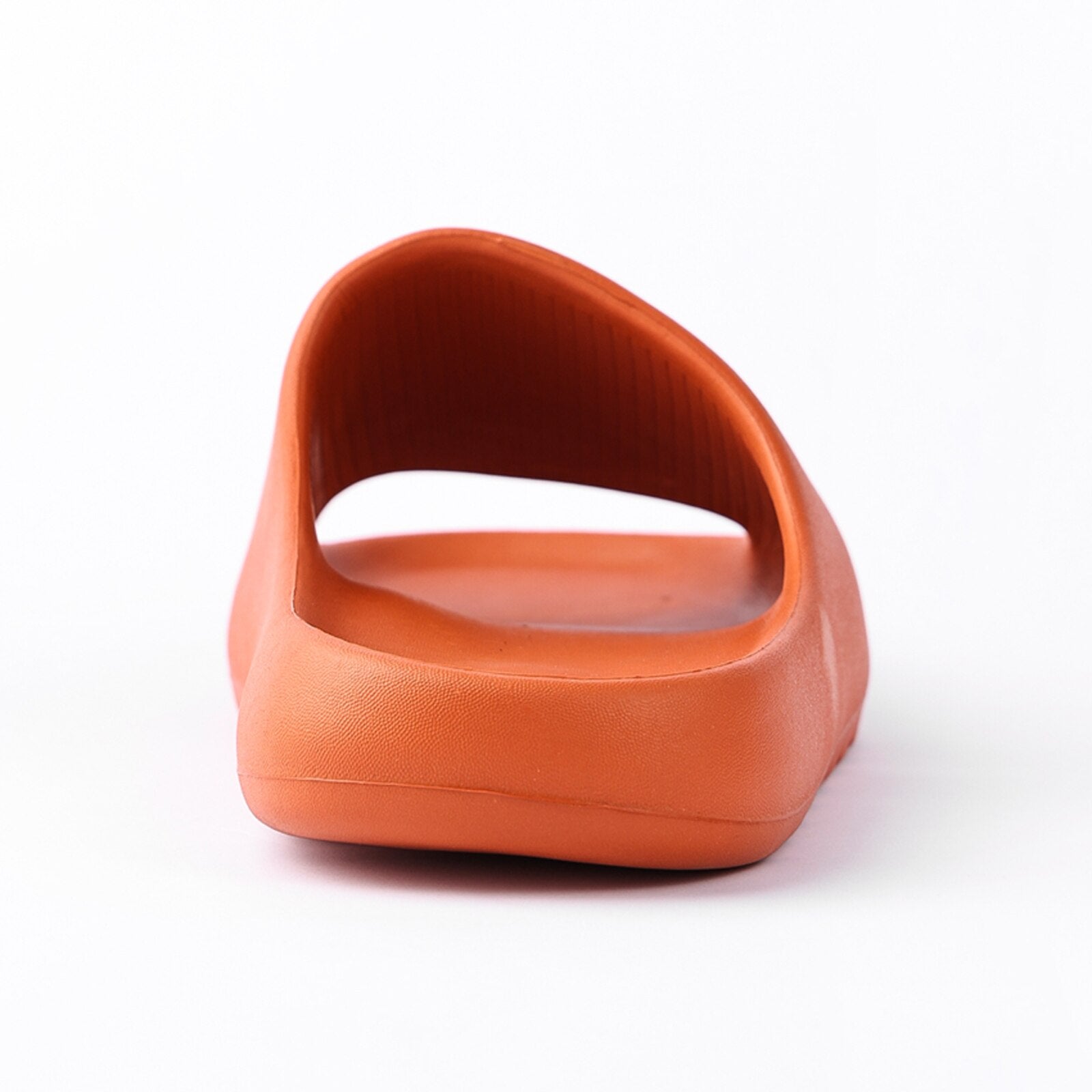 A pair of orange chunky platform pillow slides for women, featuring an open toe design and a cushioned insole, perfect for casual wear and shower use.