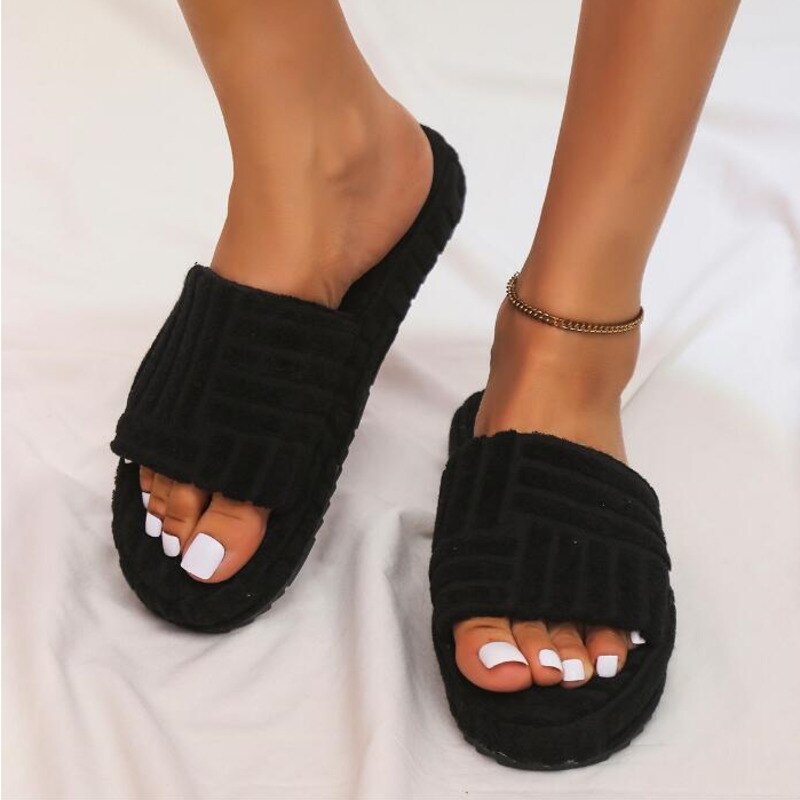 A pair of stylish Thick Bottom Embossed Cotton Fur Women Slippers featuring a soft fur lining and a thick cushioned sole, perfect for indoor comfort.