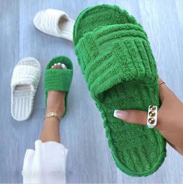 A pair of stylish Thick Bottom Embossed Cotton Fur Women Slippers featuring a soft fur lining and a thick cushioned sole, perfect for indoor comfort.