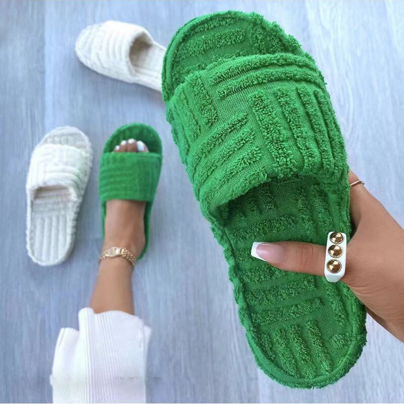 A pair of stylish Thick Bottom Embossed Cotton Fur Women Slippers featuring a soft fur lining and a thick cushioned sole, perfect for indoor comfort.