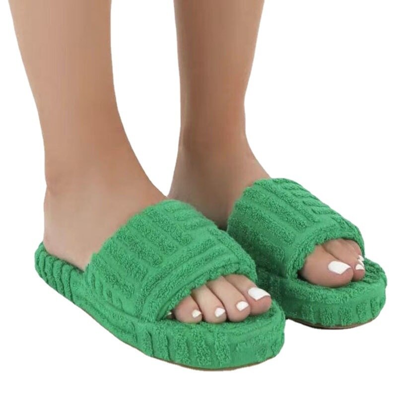 A pair of stylish Thick Bottom Embossed Cotton Fur Women Slippers featuring a soft fur lining and a thick cushioned sole, perfect for indoor comfort.