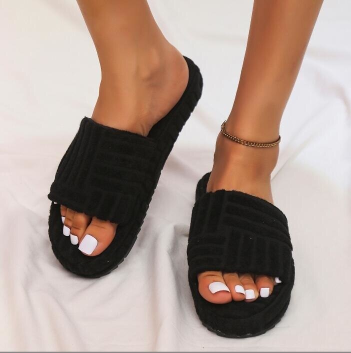 A pair of stylish Thick Bottom Embossed Cotton Fur Women Slippers featuring a soft fur lining and a thick cushioned sole, perfect for indoor comfort.