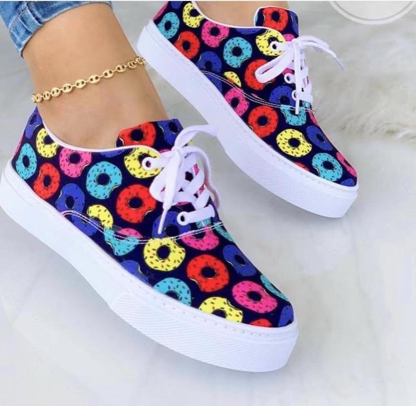 A pair of stylish 2022 Fashion Graffiti Women Sneakers featuring vibrant graffiti patterns, perfect for casual wear.