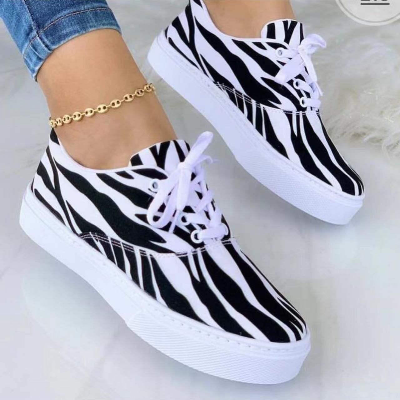 A pair of stylish 2022 Fashion Graffiti Women Sneakers featuring vibrant graffiti patterns, perfect for casual wear.