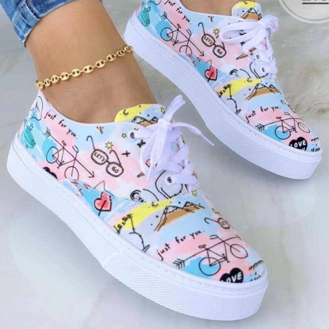 A pair of stylish 2022 Fashion Graffiti Women Sneakers featuring vibrant graffiti patterns, perfect for casual wear.