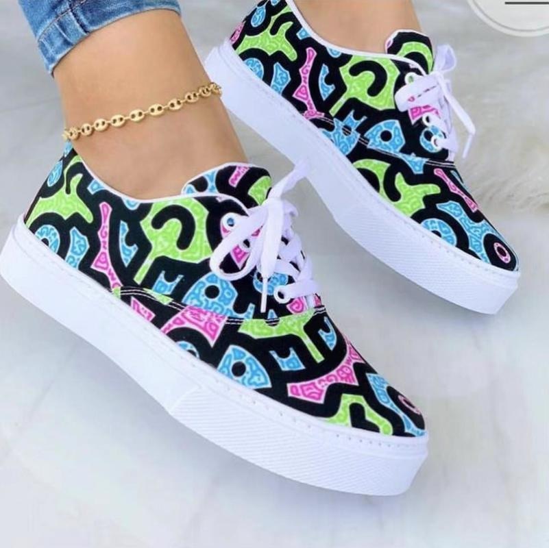 A pair of stylish 2022 Fashion Graffiti Women Sneakers featuring vibrant graffiti patterns, perfect for casual wear.