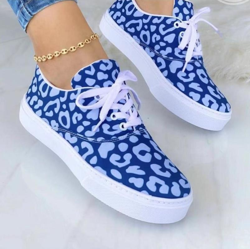 A pair of stylish 2022 Fashion Graffiti Women Sneakers featuring vibrant graffiti patterns, perfect for casual wear.