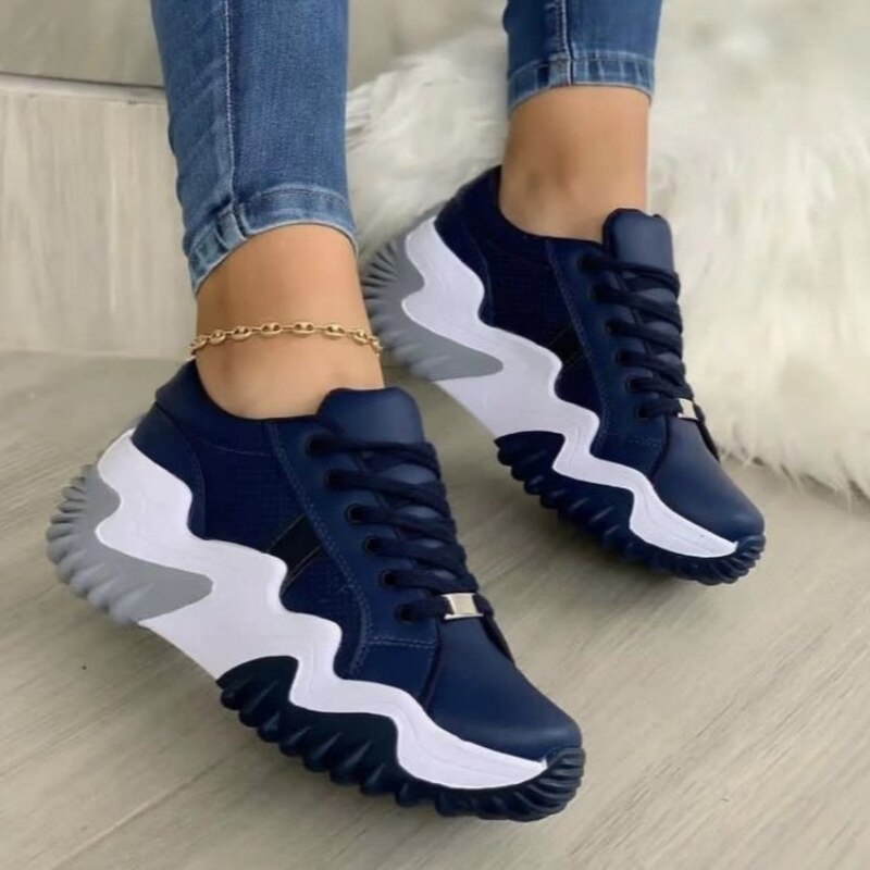 A pair of stylish breathable vulcanized women shoes in a casual platform sneaker design, showcasing their sleek look and comfortable fit.