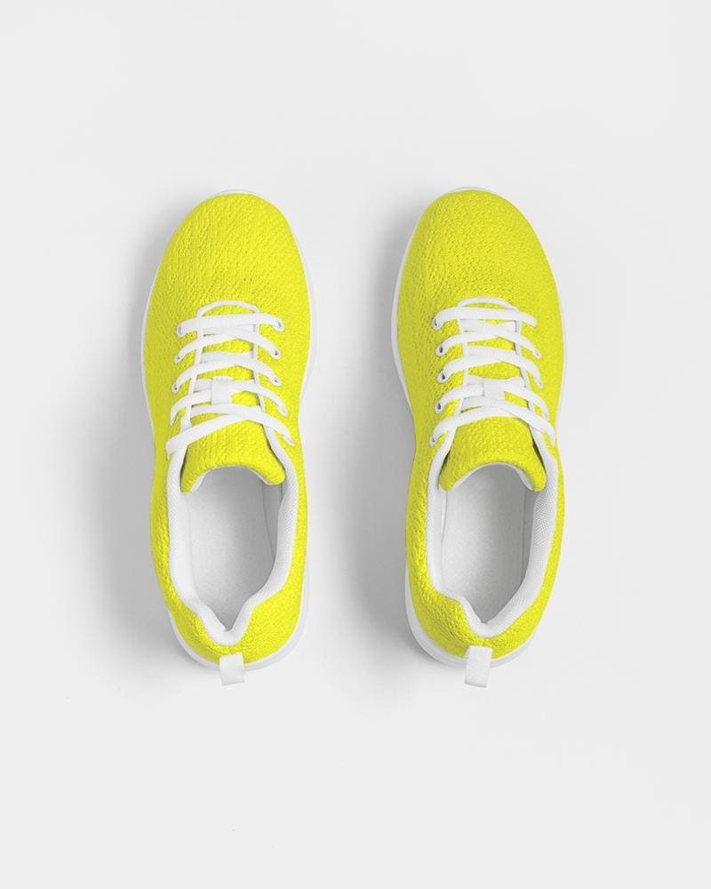 Men's yellow low top canvas running sports shoes with lace-up front, breathable lining, and padded collar, perfect for athletic activities.