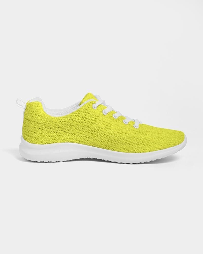 Men's yellow low top canvas running sports shoes with lace-up front, breathable lining, and padded collar, perfect for athletic activities.