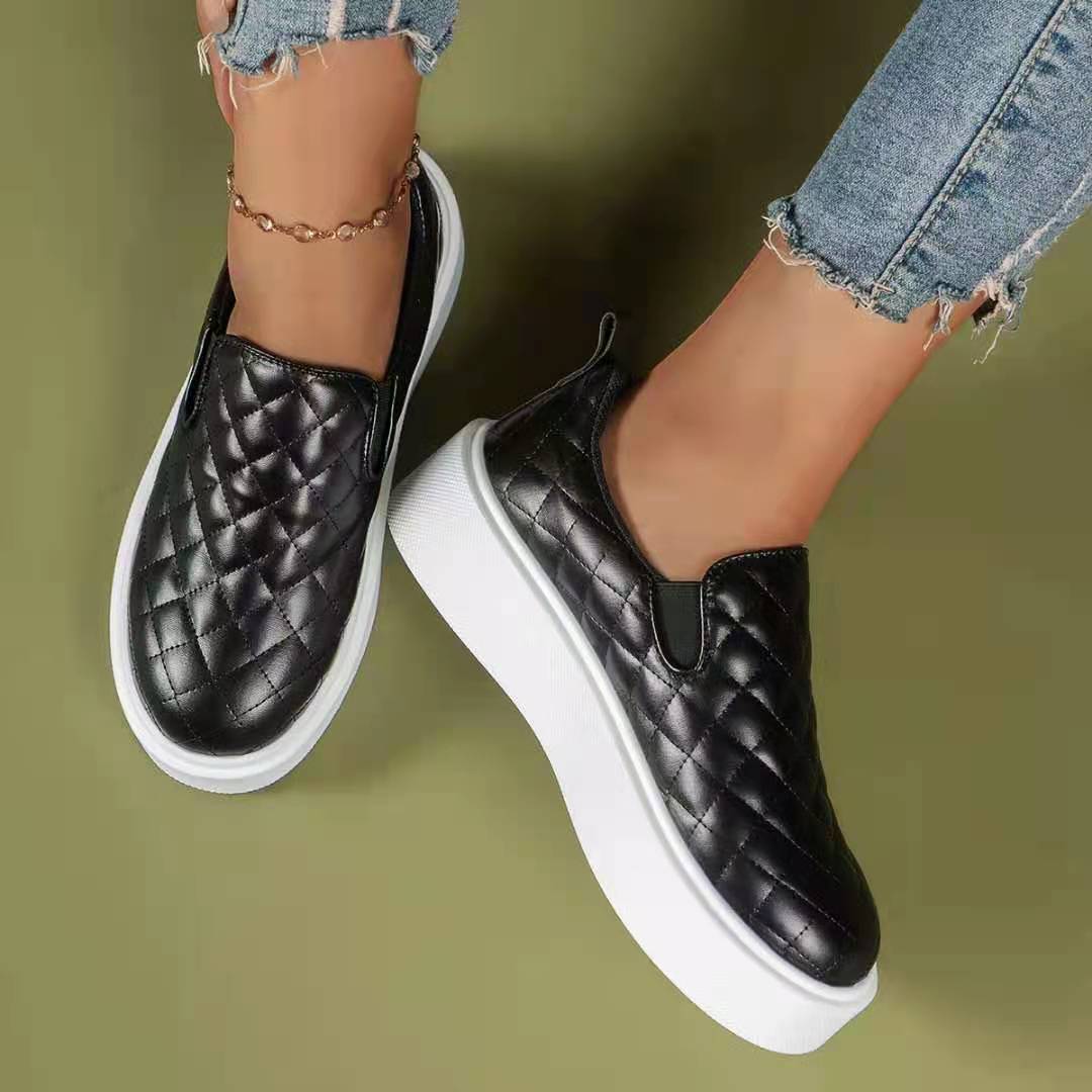 A pair of lightweight slip-on casual platform shoes in black and white, showcasing their stylish design and comfortable fit.