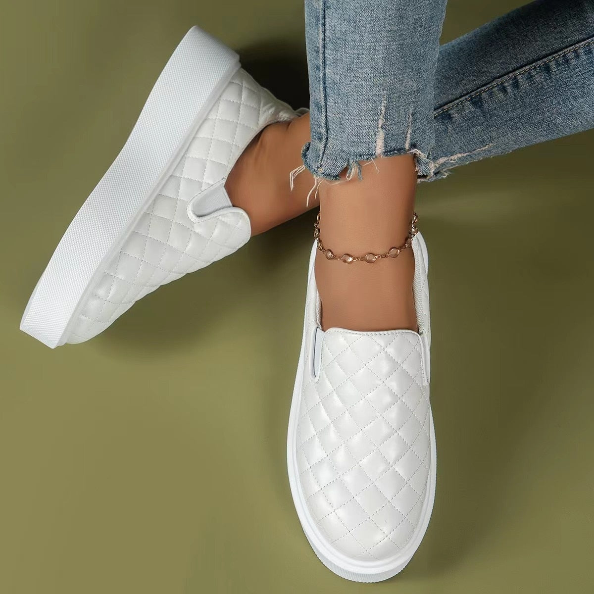 A pair of lightweight slip-on casual platform shoes in black and white, showcasing their stylish design and comfortable fit.