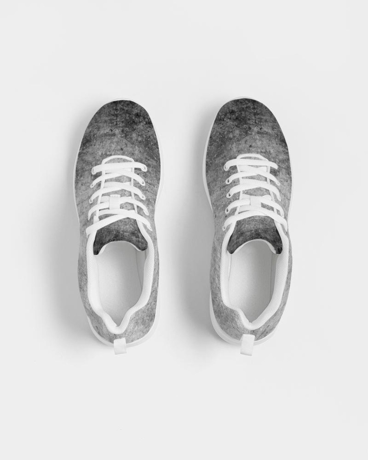 A pair of women's grey tie-dye style canvas sports shoes, featuring a lace-up front, padded collar, and soft insole, ideal for running and casual wear.