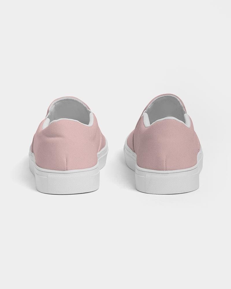 A pair of stylish women's slip-on canvas sports shoes in rose pink, featuring elastic side accents and a padded collar for comfort.