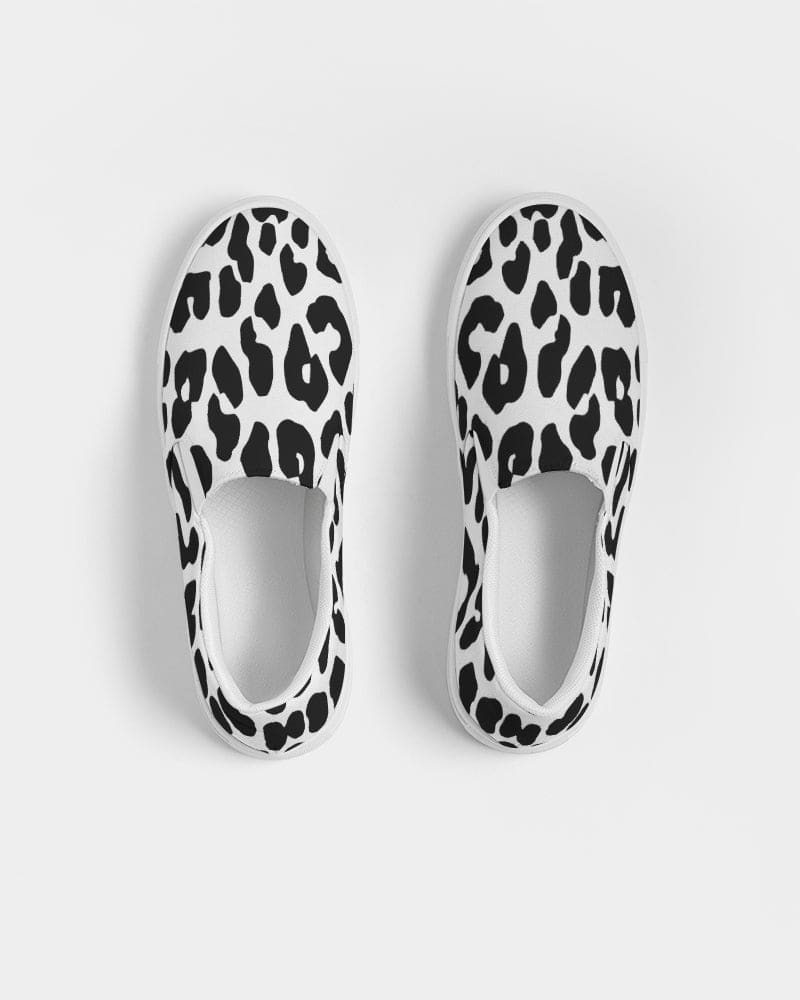 A pair of women's slip-on canvas sneakers featuring a stylish black and white leopard print design, perfect for casual wear.