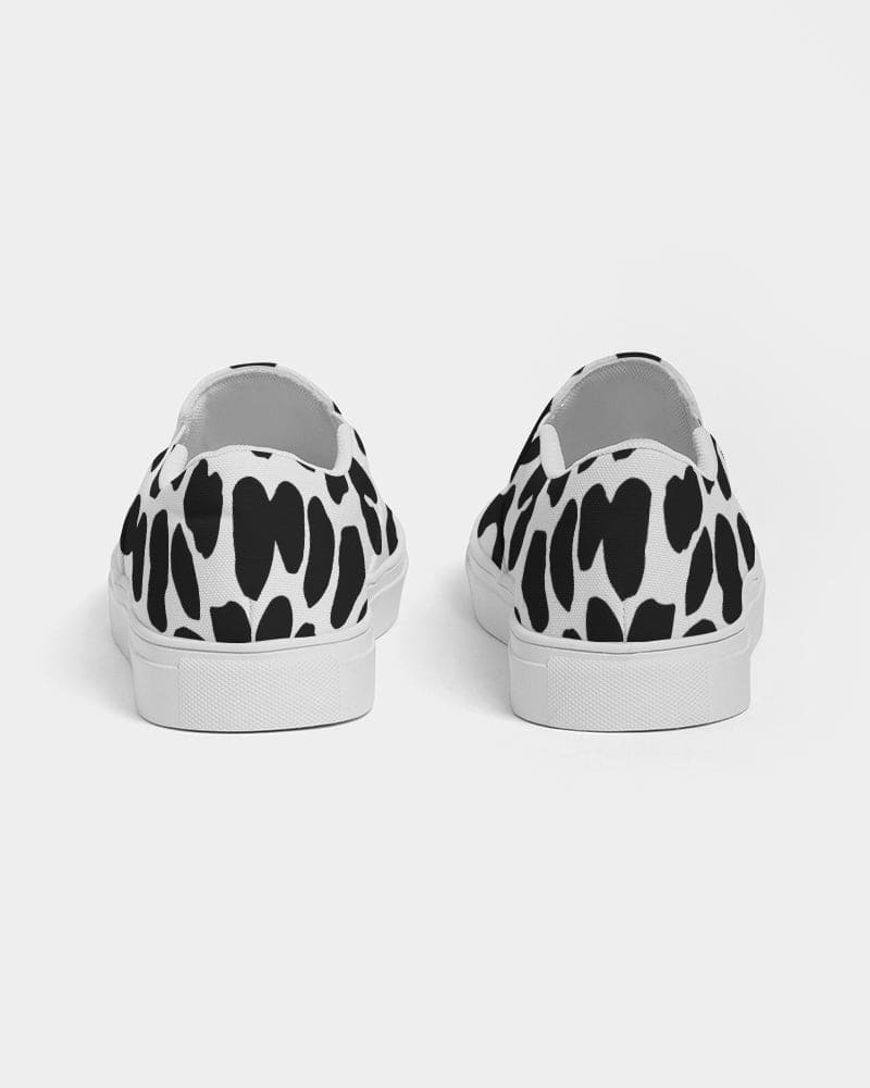 A pair of women's slip-on canvas sneakers featuring a stylish black and white leopard print design, perfect for casual wear.