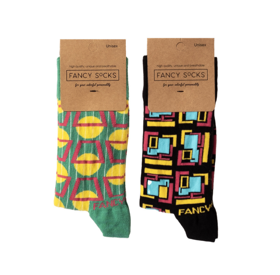 A pair of stylish black and green geometric socks displayed together, showcasing their unique design and vibrant colors.