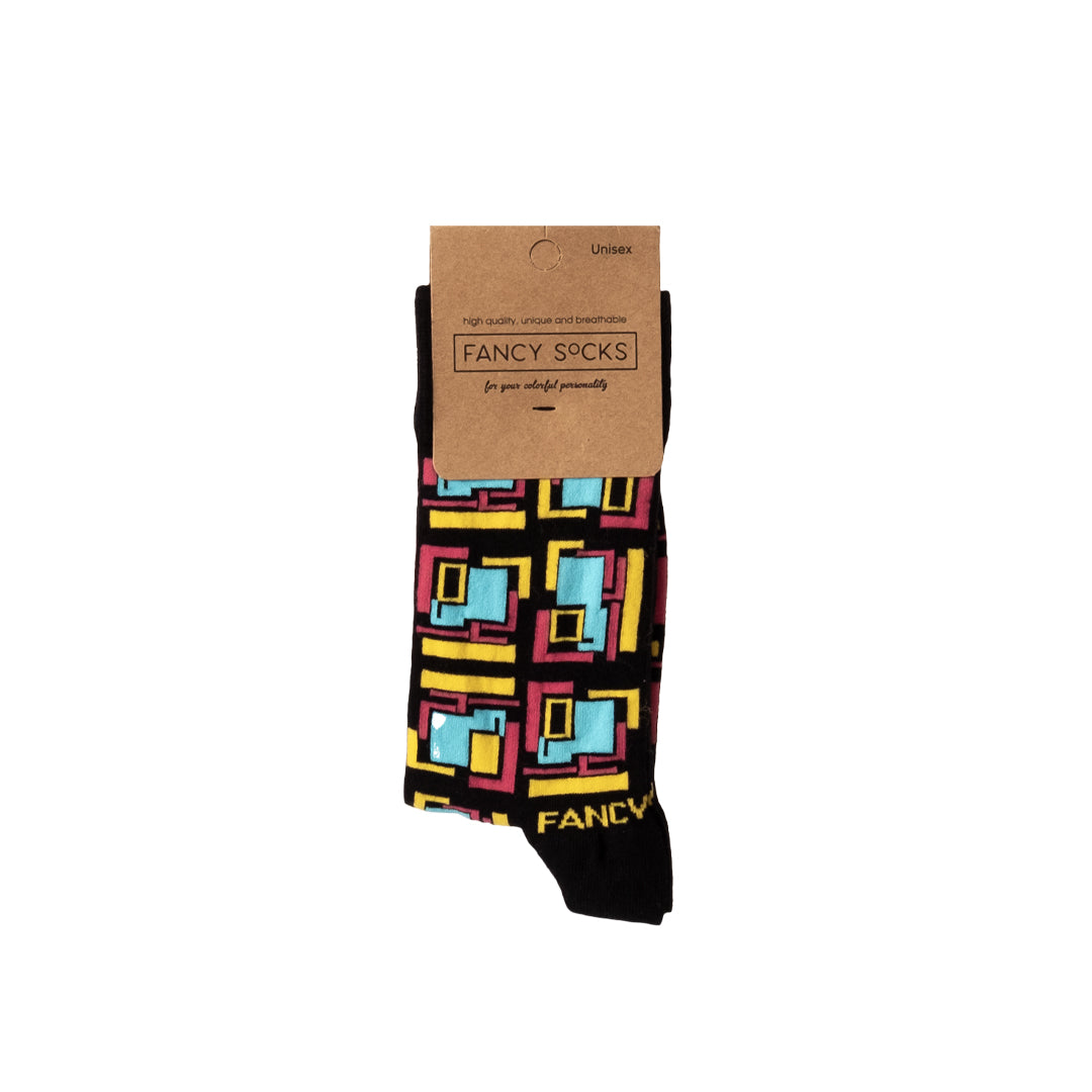 A pair of stylish black and green geometric socks displayed together, showcasing their unique design and vibrant colors.