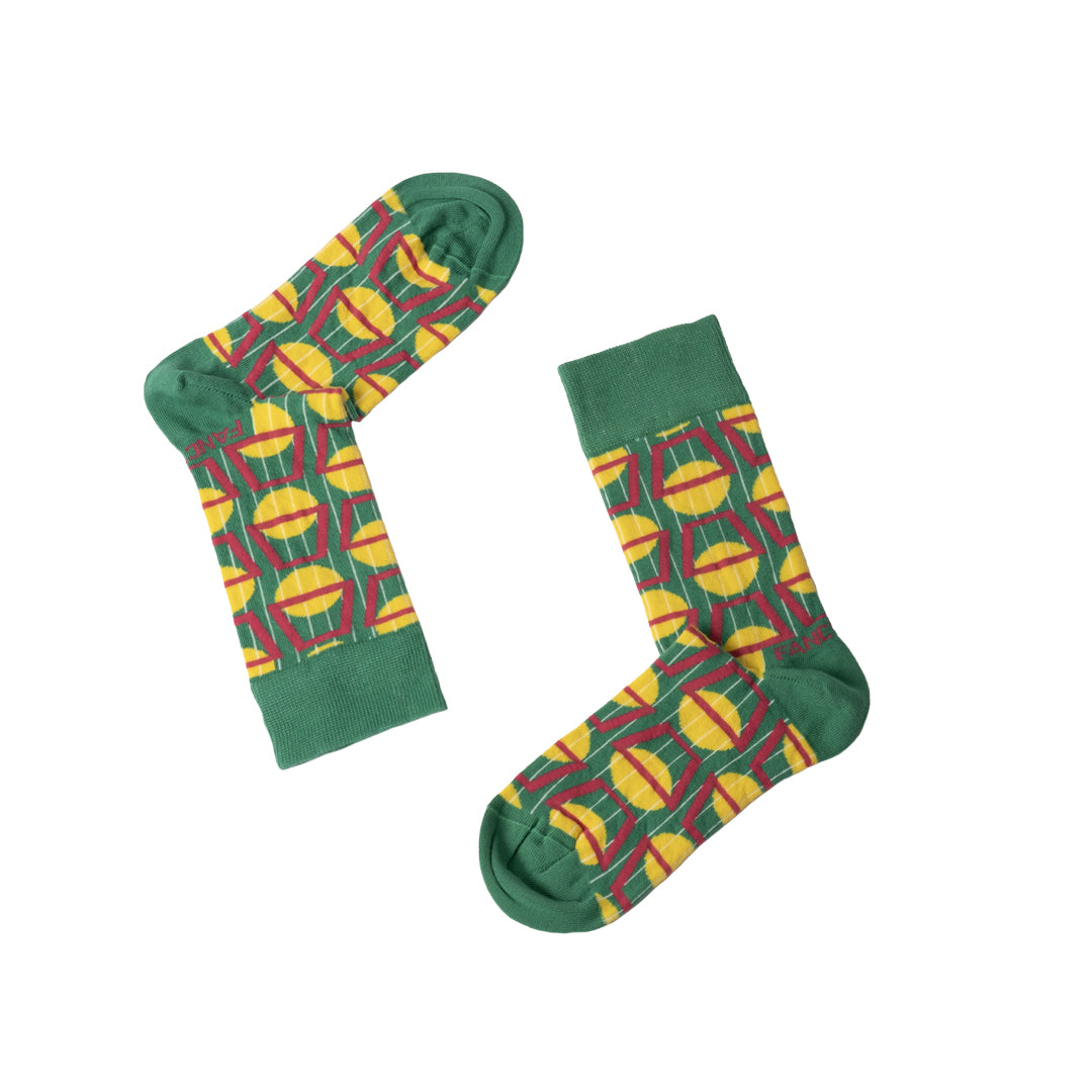 A pair of stylish black and green geometric socks displayed together, showcasing their unique design and vibrant colors.