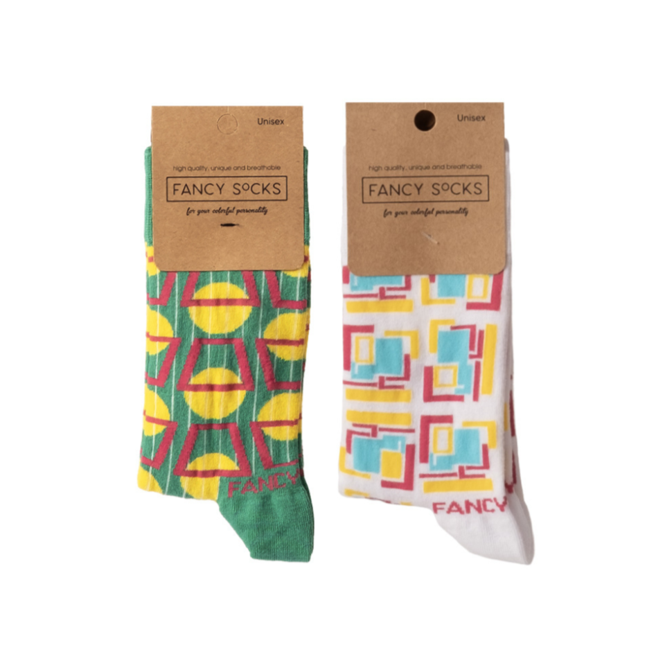 A pair of green and white geometric socks displayed together, showcasing their stylish design and comfortable fabric.