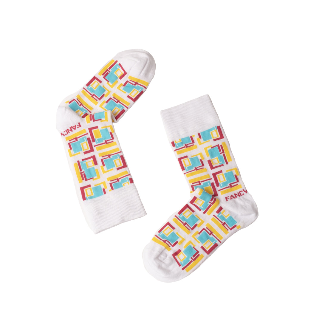 A pair of green and white geometric socks displayed together, showcasing their stylish design and comfortable fabric.