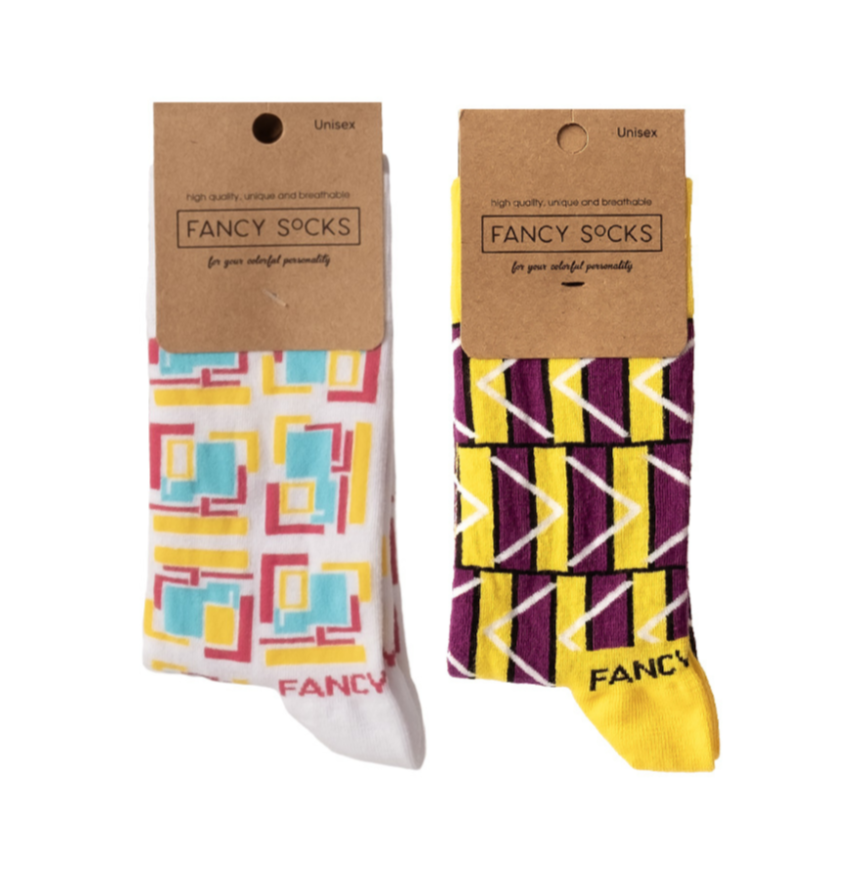 A pair of purple and white geometric socks displayed together, showcasing their stylish design and vibrant colors.