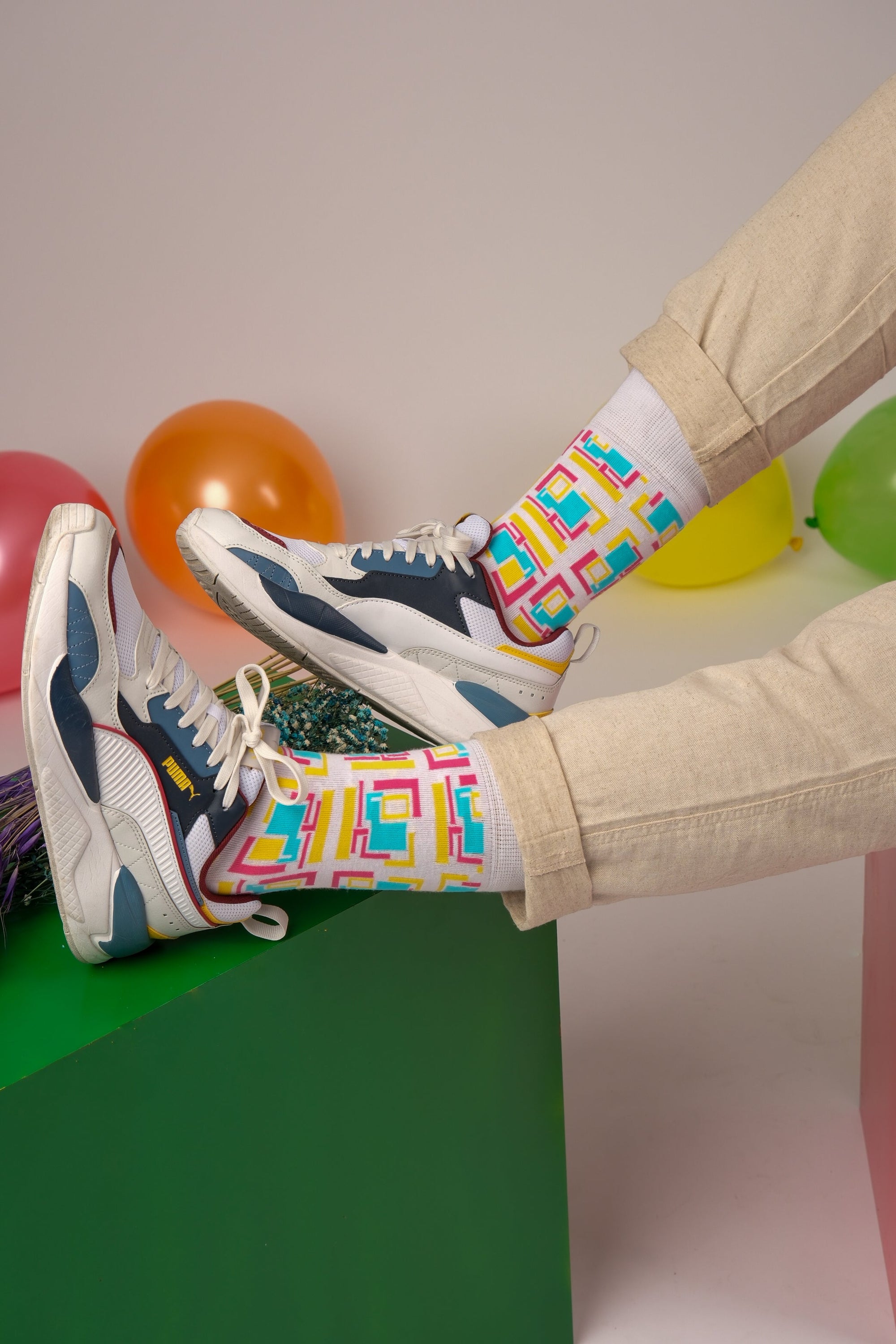 A pair of purple and white geometric socks displayed together, showcasing their stylish design and vibrant colors.