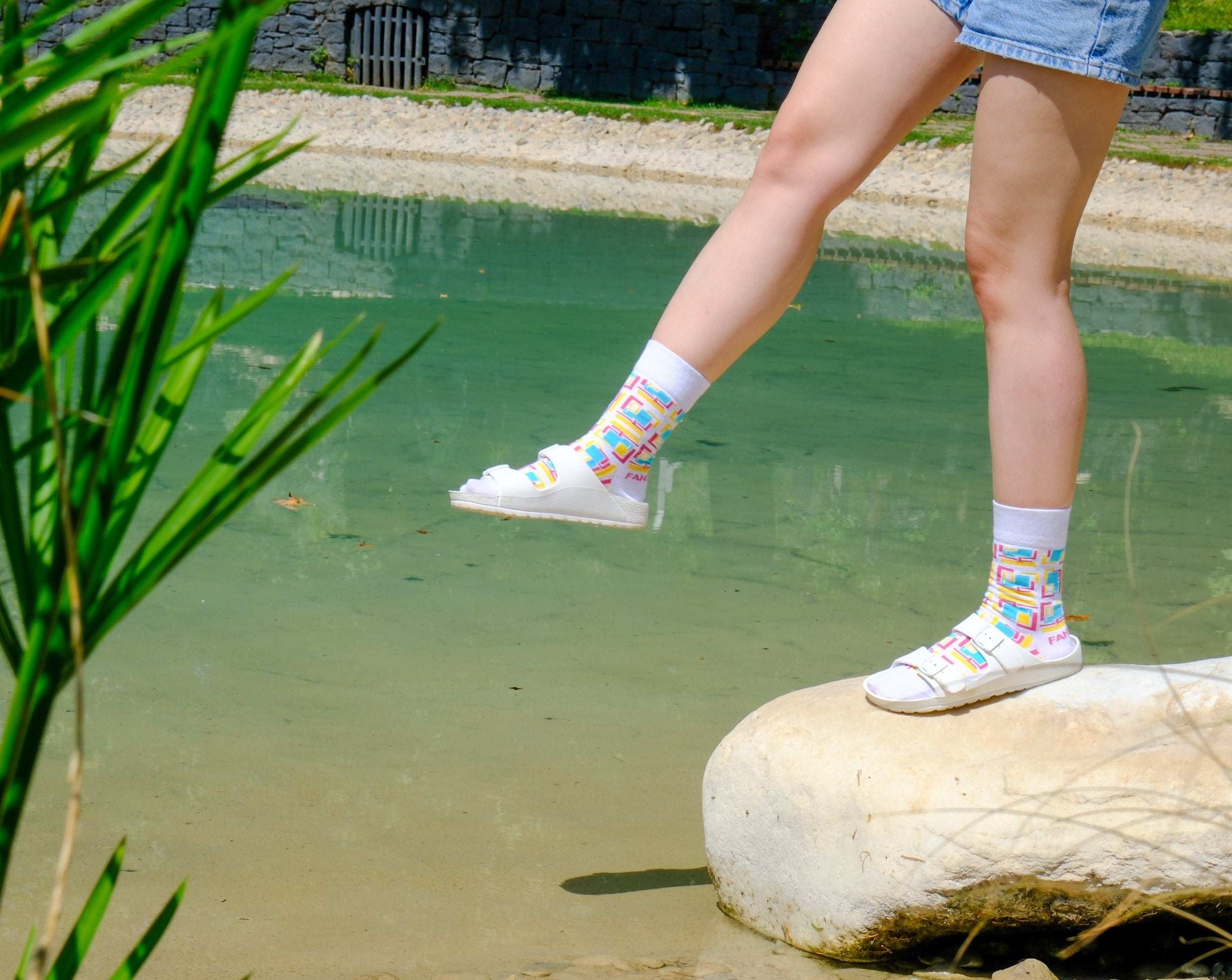 A pair of purple and white geometric socks displayed together, showcasing their stylish design and vibrant colors.