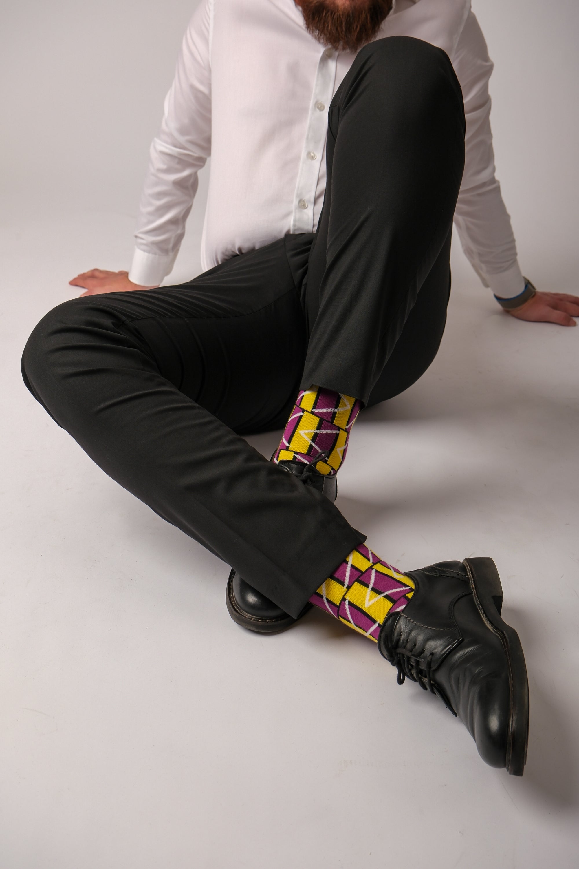 A pair of purple and white geometric socks displayed together, showcasing their stylish design and vibrant colors.