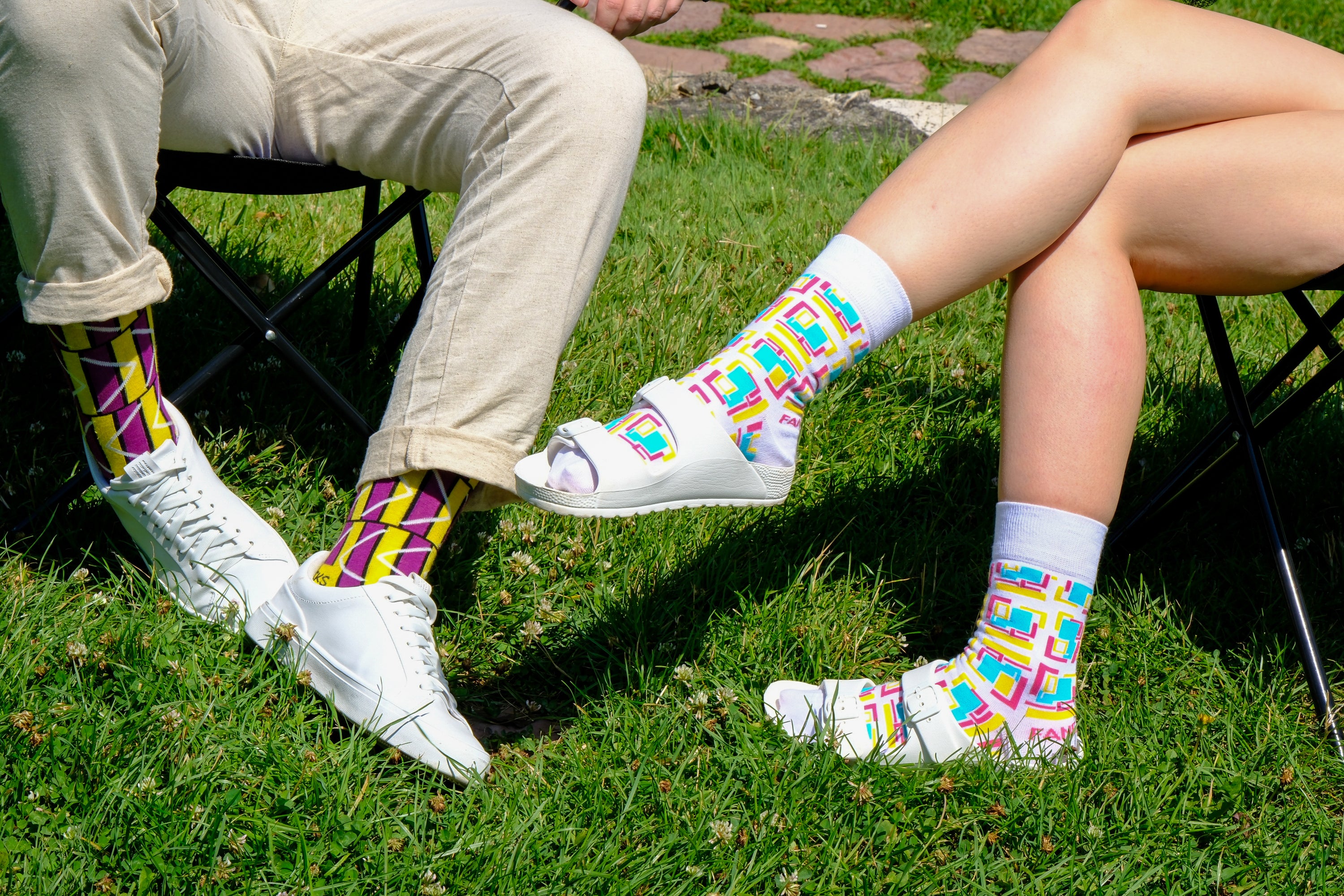 A pair of purple and white geometric socks displayed together, showcasing their stylish design and vibrant colors.