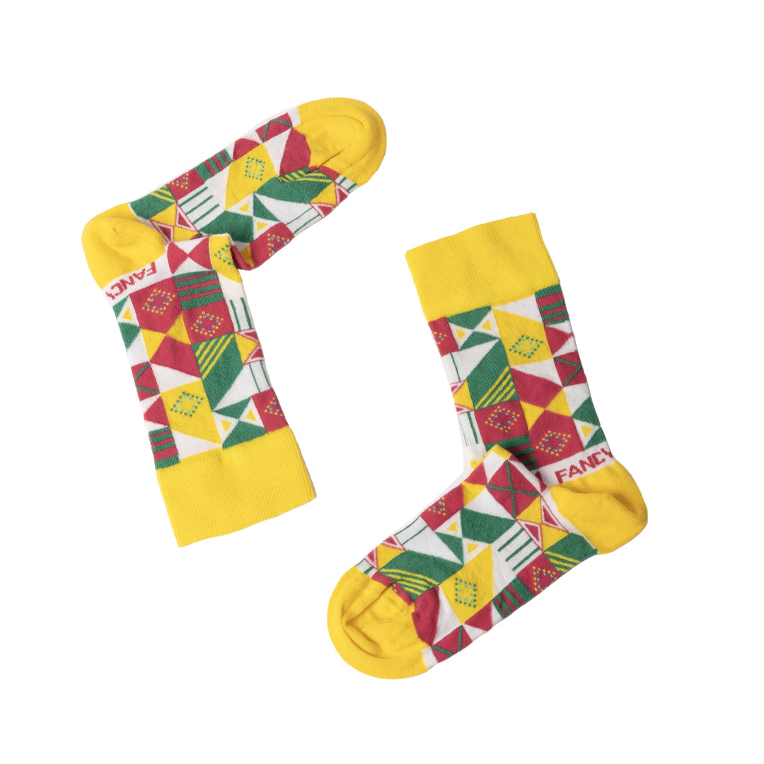 A pair of vibrant yellow and green geometric socks displayed together, showcasing their unique patterns and soft texture.