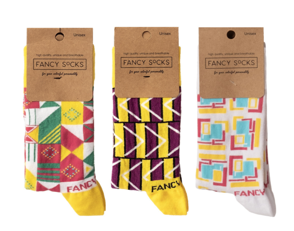 A vibrant 3 pack of socks in yellow, purple, and white, showcasing their stylish design and comfortable fabric.