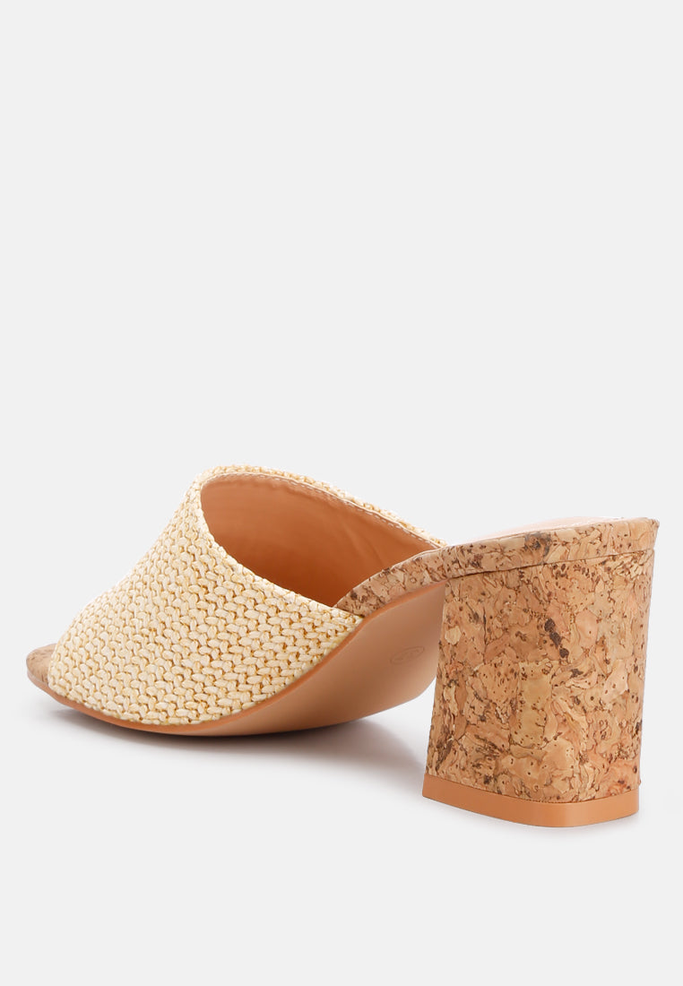 Addie Raffia Slip On Sandals featuring a stylish raffia upper, comfortable block heel, and cork texture detail, perfect for summer wear.