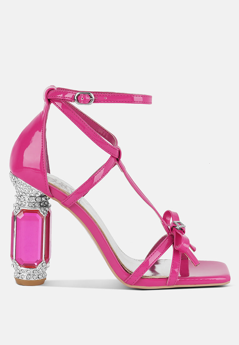 Affluence Jeweled High Heel Sandals featuring embellished bow, fantasy heel, and ankle strap for stylish summer wear.