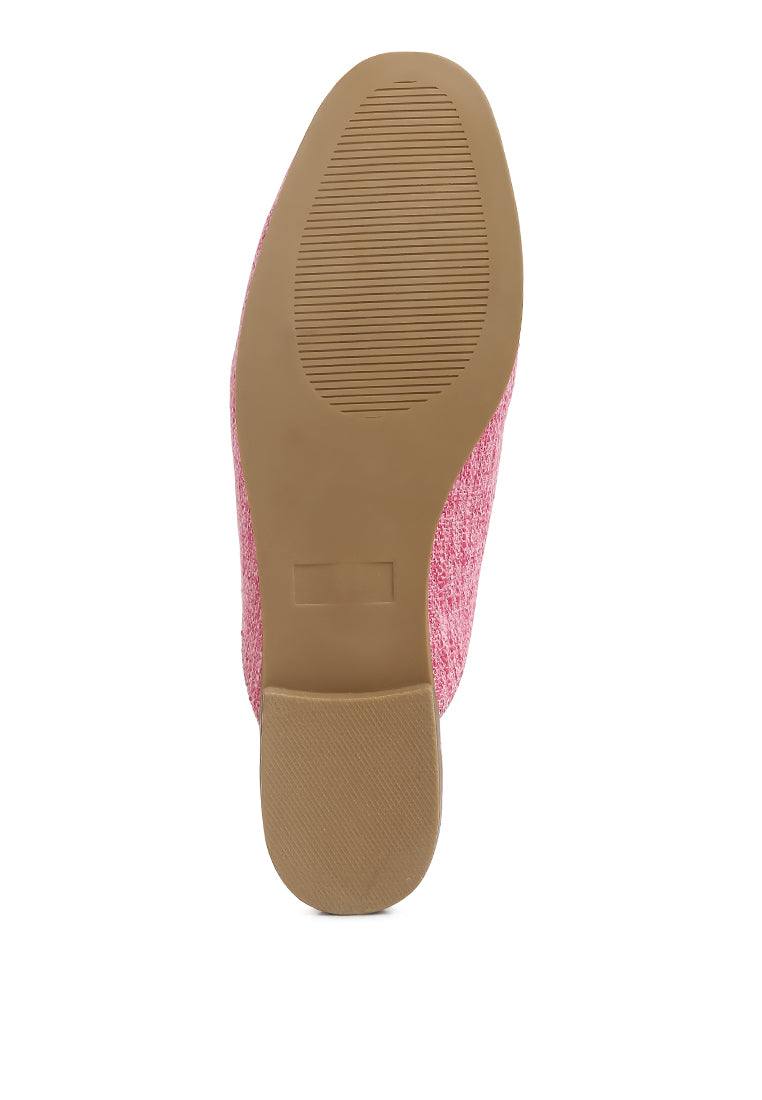 Stylish Akua Horsebit Embellished Mules featuring a classic horsebit design, low heel, and textured canvas upper.