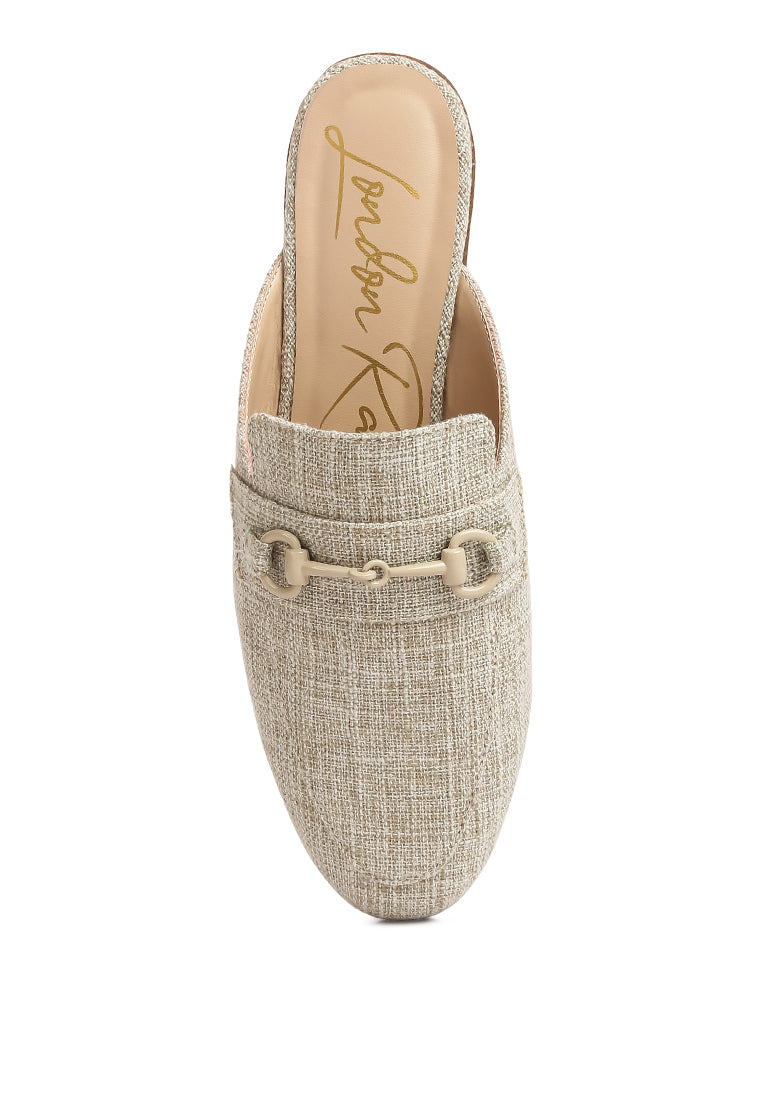 Stylish Akua Horsebit Embellished Mules featuring a classic horsebit design, low heel, and textured canvas upper.