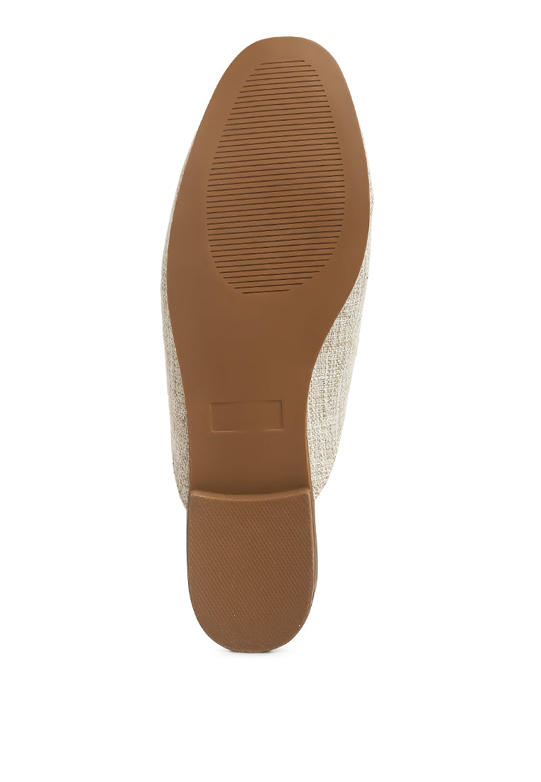 Stylish Akua Horsebit Embellished Mules featuring a classic horsebit design, low heel, and textured canvas upper.