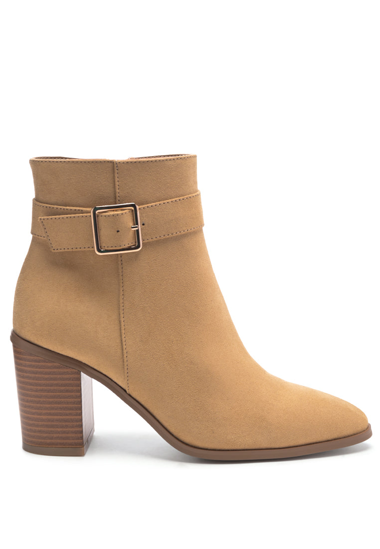 Stylish taupe faux suede ankle boots with pointed toe and buckle detail, featuring a side zipper and block heel.