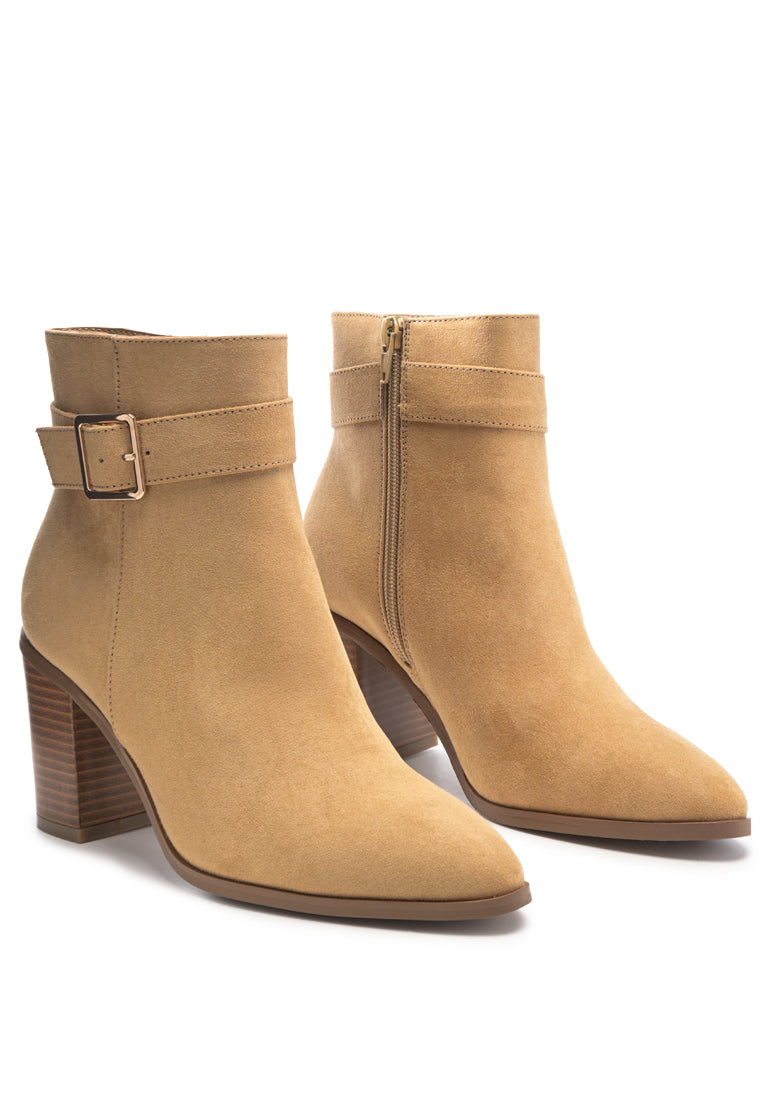 Stylish taupe faux suede ankle boots with pointed toe and buckle detail, featuring a side zipper and block heel.