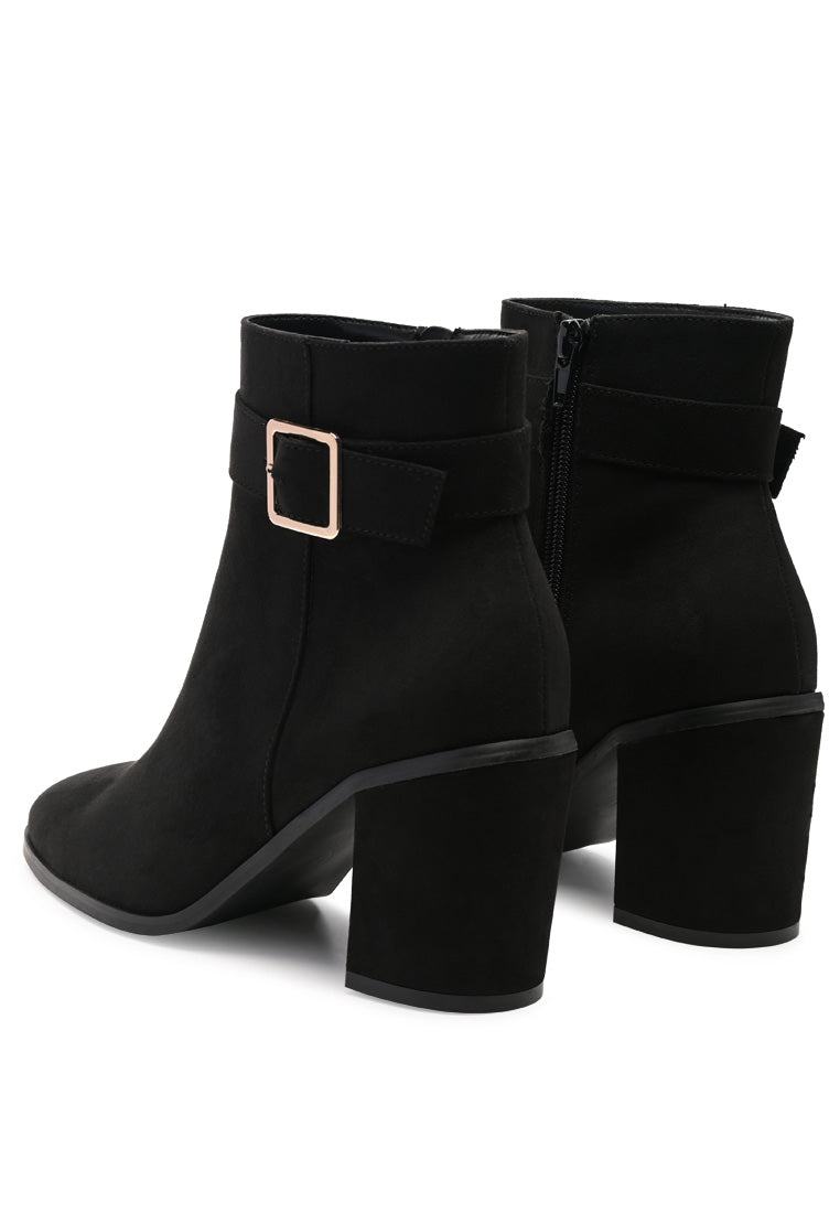 Stylish taupe faux suede ankle boots with pointed toe and buckle detail, featuring a side zipper and block heel.