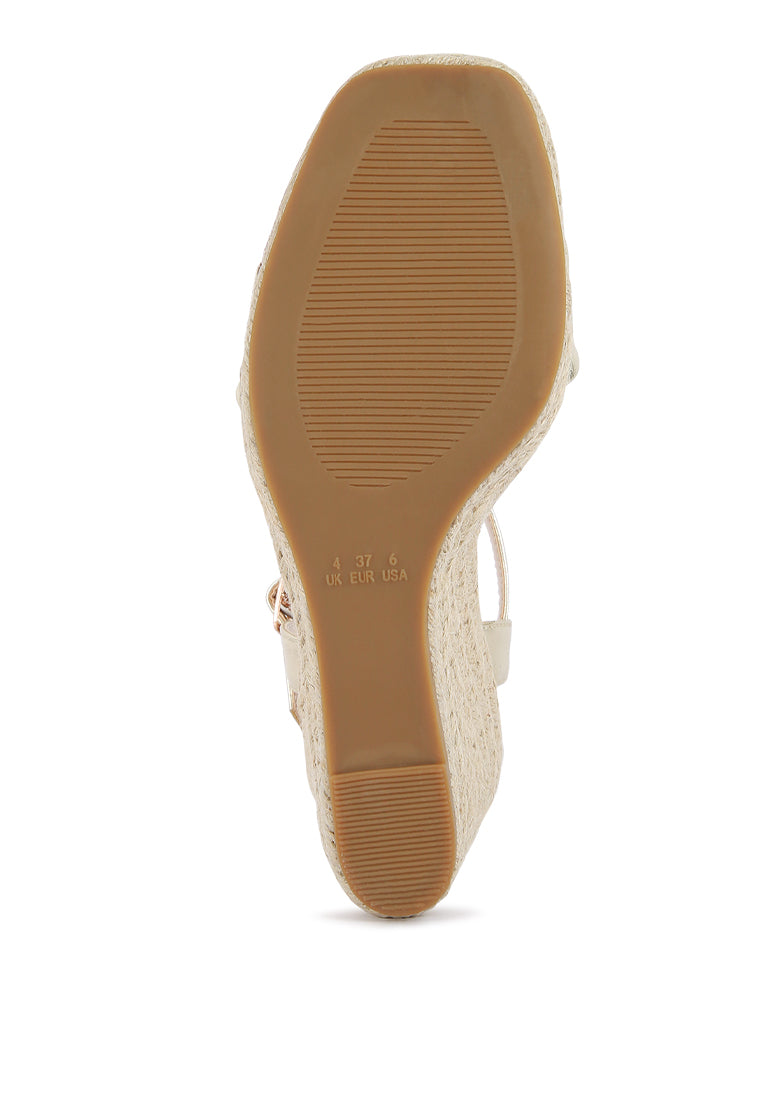 Augie Woven Wedge Sandals featuring a square open toe, metallic pin buckle, and espadrille detail on the wedge.