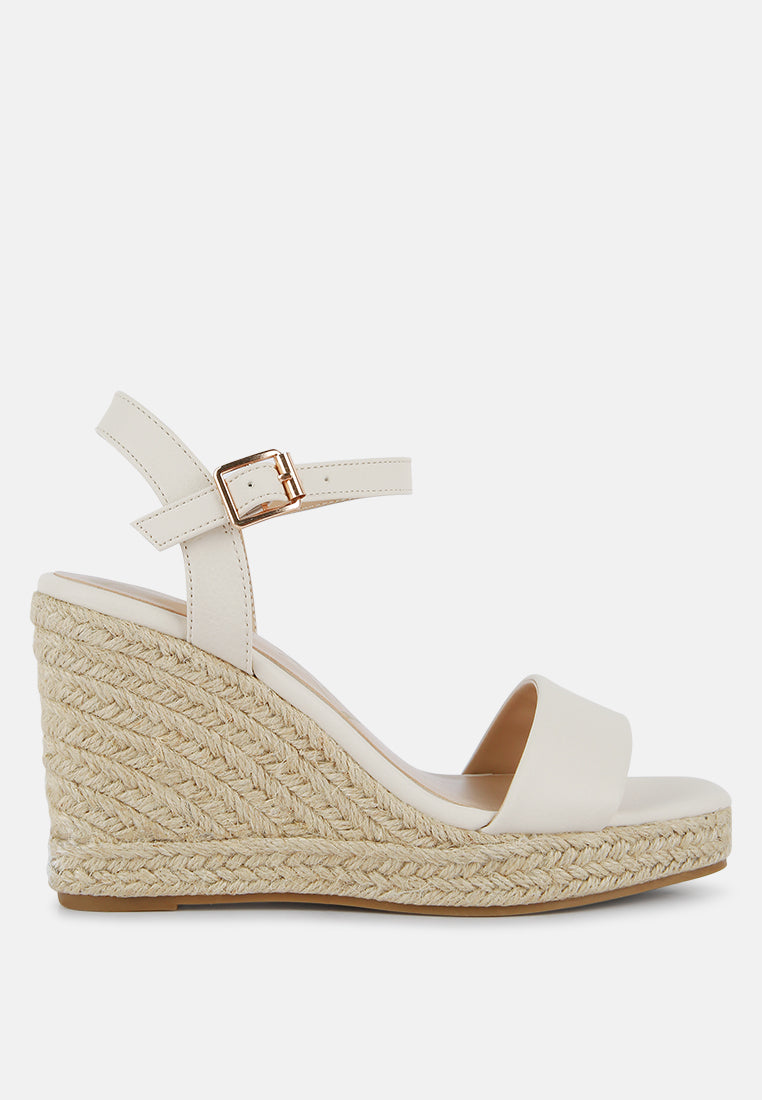 Augie Woven Wedge Sandals featuring a square open toe, metallic pin buckle, and espadrille detail on the wedge.